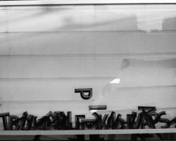 Broken signboard with jumbled letters and PI