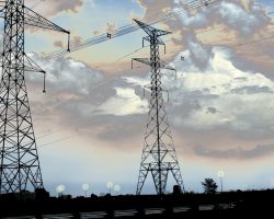 Hydro towers with beautiful, threatening clouds behind, and streetlights wasting electricity Hydro towers with beautiful, threatening clouds behind, and streetlights wasting electricity