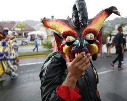 Parade participant shows devil mask in parade in Samana, Dominican Republic